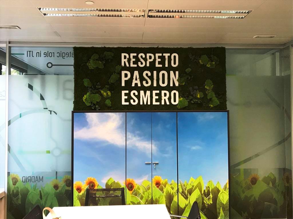 Mural plantas artificiales con eslogan en oficina